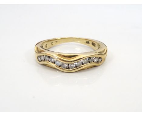 CHANNEL SET DIAMOND RING
the diamonds in wavy setting totalling approximately 0.25cts, on nine carat gold shank, ring size K-