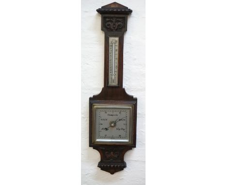 OAK CASED BAROMETER
of shaped outline with a circular silvered dial below a thermometer with a silvered scale, 58.5cm high 