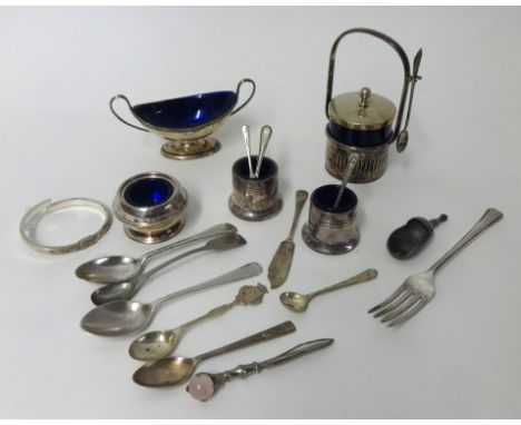 A London twin handled silver table salt with blue glass liner, a silver bangle (broken), spoons and silver plated condiments