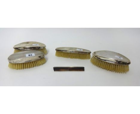 Four silver backed clothes brushes and a comb