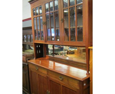 A late 19th Century French mahogany three door panel glazed sideboard, with two drawer two door base, 235cm high x 150cm wide