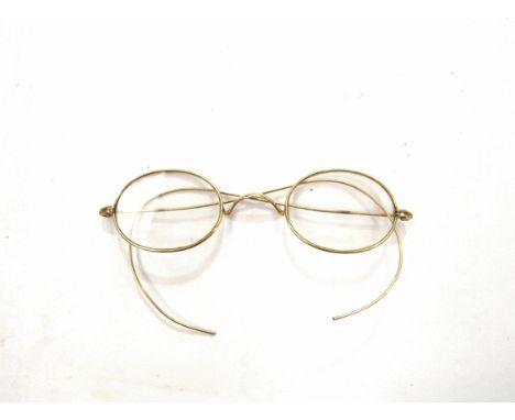 A pair of vintage yellow metal framed spectacles