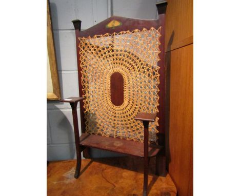 An Art Nouveau mahoganany fire screen with cane work panel