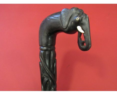 An African carved ebony walking stick with elephant head handle. Missing ferrule to base (92cm long)