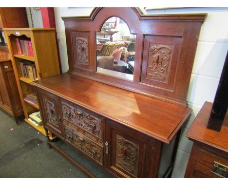 An oak sideboard with carved panel front and arched mirror back, 152cm wide x 50cm deep x 168cm high