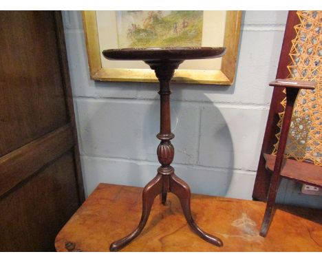 A Georgian style mahogany wine table the dished circular top on turned and fluted column over a tripod base, 49cm tall x 27cm