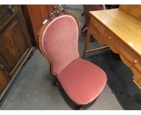 An early Victorian walnut bedroom chair the spoon backrest with carved crest over scroll front carved legs on white ceramic c