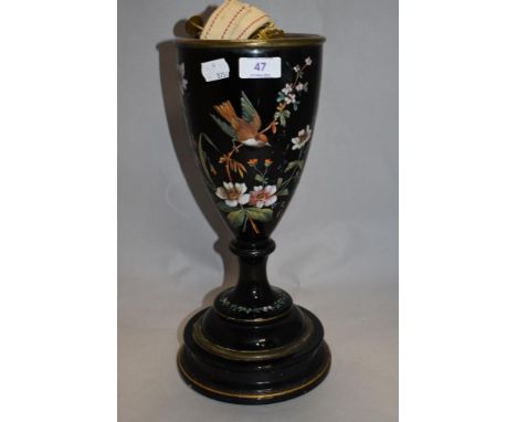 A Victorian black ceramic lamp base, having enamelled bird and floral pattern and gilt heightening.