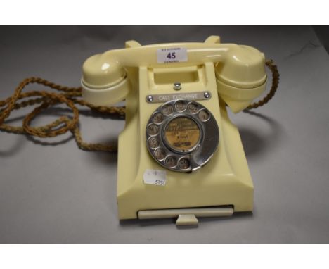 A mid century cream plastic GPO call exchange rotary telephone, having integrated draw to house a note pad of phone numbers.