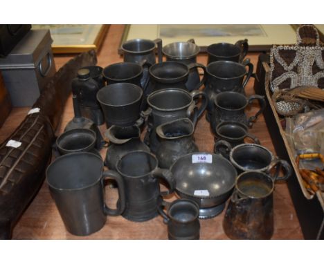A collection of pewter tankards and similar items, including plated jug, funnel and engraved hip flask.