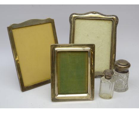 Three silver fronted picture easel frames; arched top and oak mount by, Sanders &amp; Mackenzie H22cm, rectangular form by E 