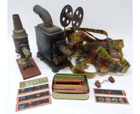 Early 20th century black japanned metal hand cranked projector, embossed ML, with curving chimney H23cm, with a quantity of f