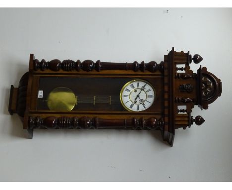 Late 19th century walnut Vienna style wall clock, shaped pediment, brass and enamel dial with Roman numerals and Gustav Becke