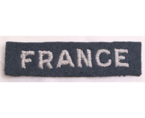 WW2 Royal Air Force France Nationality Shoulder Title, embroidered white on light blue shoulder title. In good overall condit