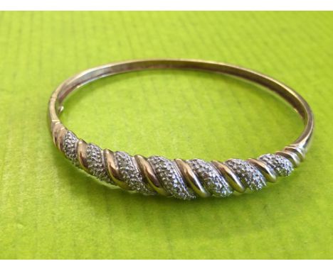 9CT GOLD AND DIAMOND CHIP ENTWINED BANGLE 9.9G APPROX