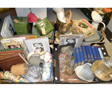A cake stand with a glass dome; a Union Jack pattern tea pot; ceramic mugs; storage tins; books; photograph frames; Champagne