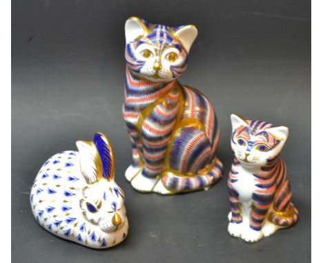 Royal Crown Derby - a seated cat paperweight; another, seated kitten; a rabbit, two first quality, one second quality (3)