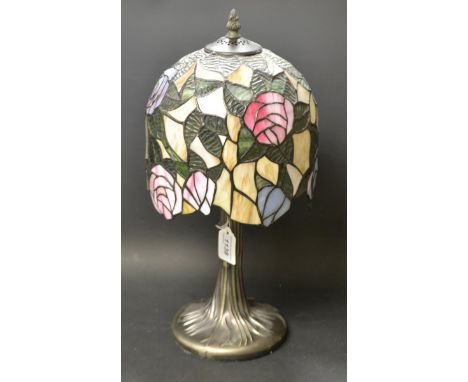 A Tiffany style table lamp decorated with roses.