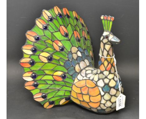 A Tiffany style table lamp in the form of a Peacock