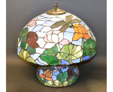 A Tiffany style table lamp decorated with dragon flies and water lilies 