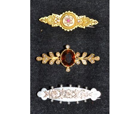 A Victorian seed pearl and citrine brooch,  central orange oval citrine, mounted between two foliate arms each encrusted with