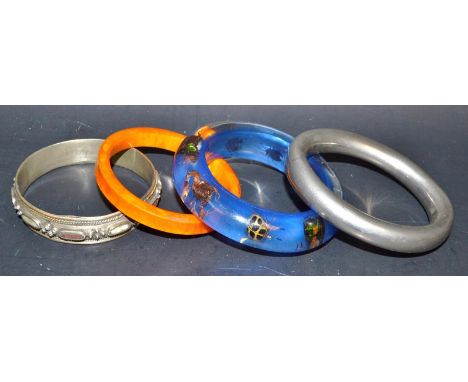 An Art Deco Bakelite bangle; an insect bangle; a silver bangle; a stone set bangle (4)