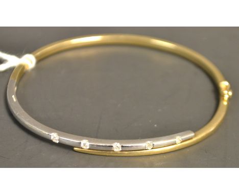 A contemporary diamond hinge bangle, linear set with five individually mounted round brilliant cut diamonds, to the white gol