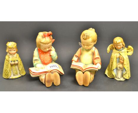 A Goebel figure of angel with a child; another similar; a  pair of West German children reading a book (4)
