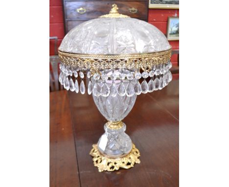 A gilt and ornate glass table lamp, decorated with glass droplets to the shade