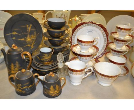 A Oriental egg shell tea service,gilt landscape on a black ground; a Staffordshire tea set for six