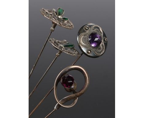 Four vintage hat pins: a Charles Horner silver hat pin with a circular amethyst swivel top; a silver hat pin with a knot &amp