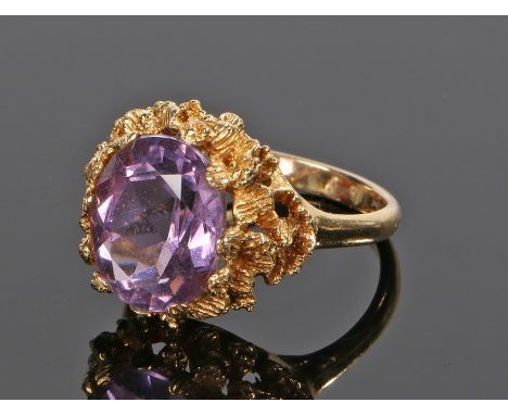 9 carat gold amethyst ring, with a facetted oval amethyst and petal surround, ring size N