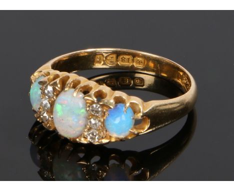 18 carat gold opal and diamond set ring, with three opals divided by three diamonds to either side of the central opal, ring 