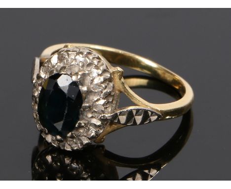 18 carat gold sapphire and diamond set ring, the oval sapphire with a diamond surround, ring size L 1/2