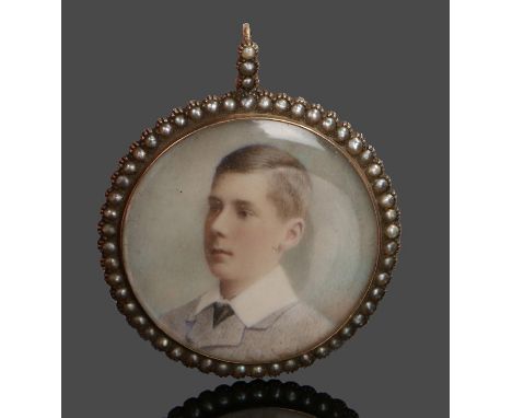 Edwardian portrait miniature pendant, with a portrait of a young man housed within the pearl set mount, 41mm diameter 