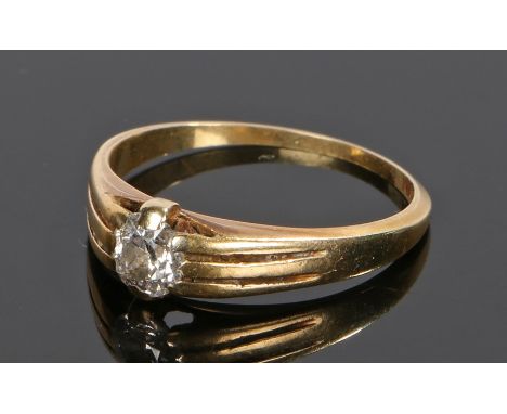 18 carat gold diamond solitaire ring, the round cut diamond held to the high shoulders, ring size P