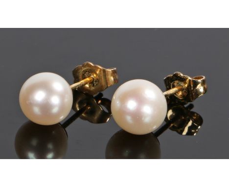 Pair of pearl earrings, with 14 carat gold mounts, 7mm diameter 