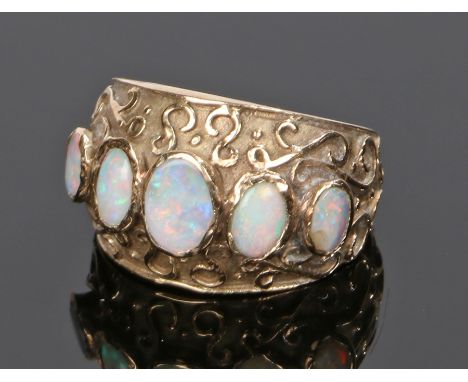 9 carat gold opal set ring, with a row of five opals to the wide head, 4.8 grams, ring size L