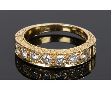 18 carat gold diamond set ring, with a row of seven round cut diamonds to the shank, ring size Q