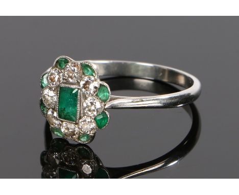 Art Deco white metal diamond and emerald set ring, the central baguette cut emerald with diamond and emerald surround, ring s