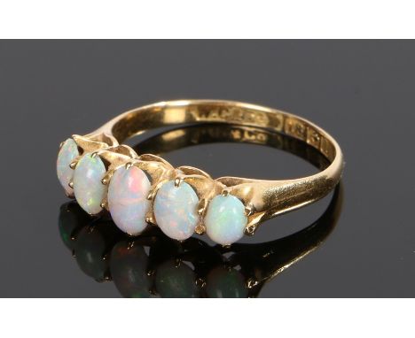 18 carat gold opal set ring, with five cabochon opals to the head, ring size M