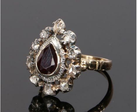 19th Century garnet and diamond set ring, the central pear cut garnet with a rose cut diamond surround, ring size K