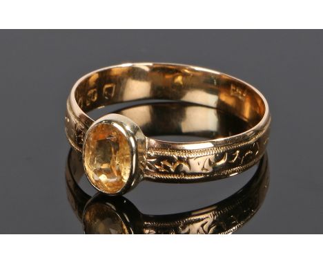 George III 18 carat gold imperial topaz set ring, assayed for London 1808, the oval topaz set to a wriggle design band, ring 