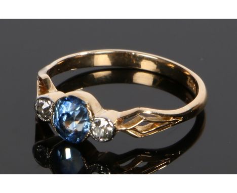 18 carat gold sapphire and diamond set ring, the central oval sapphire flanked by a round cut diamond, ring size J