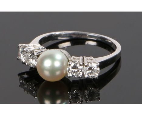 18 carat white gold pearl and diamond set ring, with a central pearl flanked by four round cut diamonds at an estimated diamo