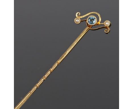 Blue topaz and pearl set stick pin, the central topaz flanked by pearls