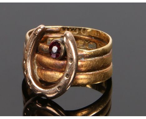 18 carat gold and garnet set horse shoe ring, with a horse shoe to the front and garnet above set to the three Victorian 22 c