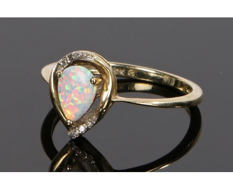 10 carat gold and opal set ring, the pear cut opal with round cut diamonds to the top and bottom, ring size N 1/2