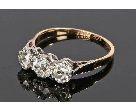 18 carat gold diamond set ring, the central diamond at approximately 0.40 carats flanked by a round cut diamond to either sid