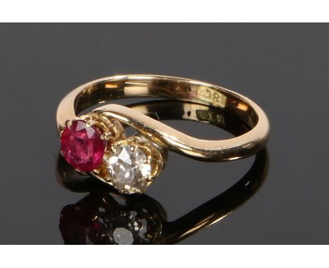 18 carat gold diamond and ruby set ring, the cross over head with a round cut diamond and ruby, ring size K 1/2